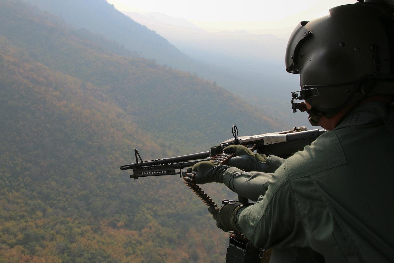 Foto eines Soldaten, der während des Flugs sein Maschinengewehr hält